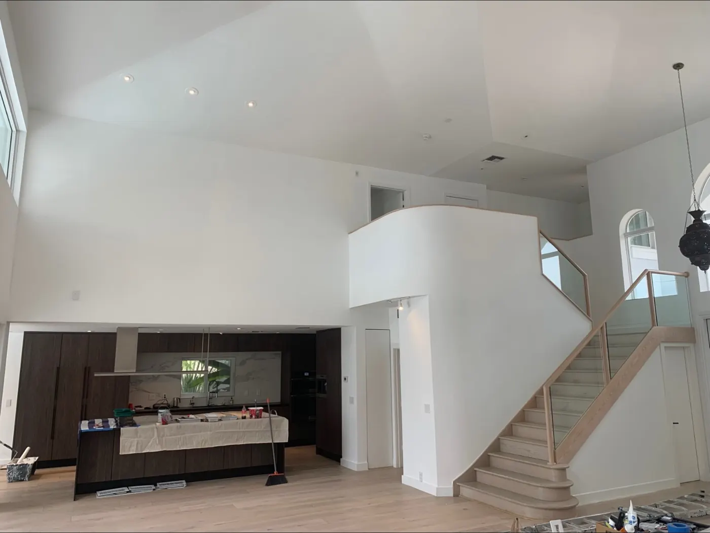 Modern great room with high ceilings painted white by All County Painters